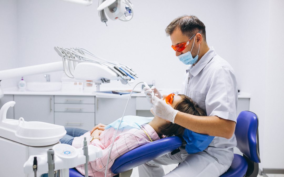 The dentist is giving treatment to a female patient